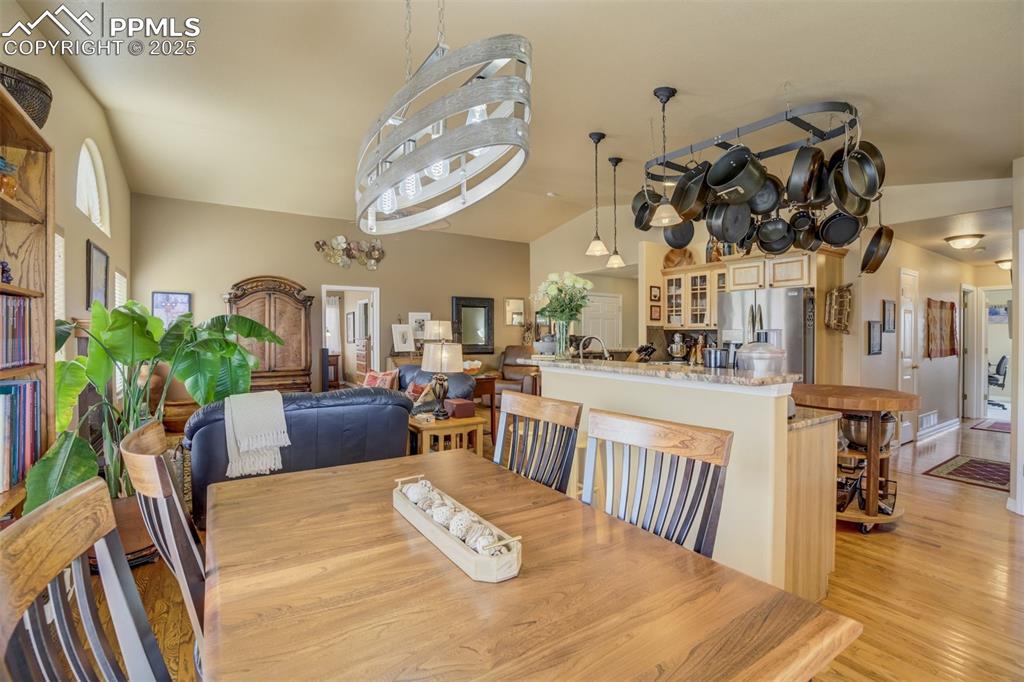 Image 13 of 50: Open Floor Plan. Looking from the Dining area into the Kitchen and Living