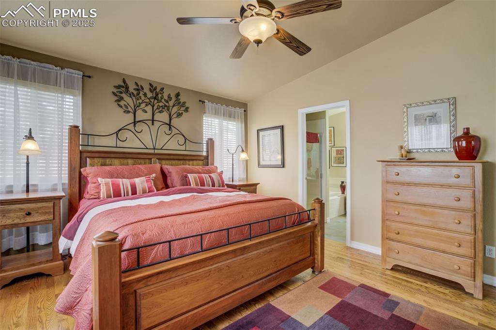 Image 15 of 50: Spacious Primary Bedroom featuring ensuite bathroom, lofted ceiling, ceilin