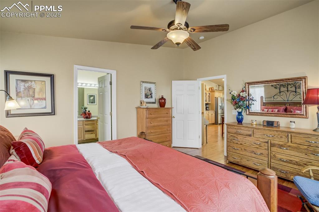 Image 17 of 50: Primary bedroom showing door into the ensuite bathroom and door into the op