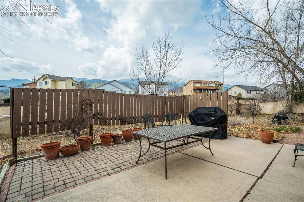 Image 38 of 50: View of patio featuring a fenced backyard and area for grilling