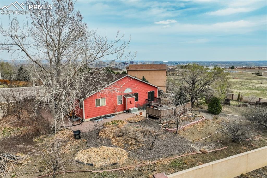 Image 39 of 50: Drone photography view showing the back of the home, backyard and patio.The