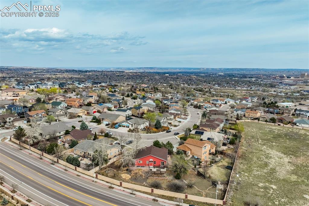 Image 41 of 50: Drone Photography view showing the striking ranch home on the third of an a