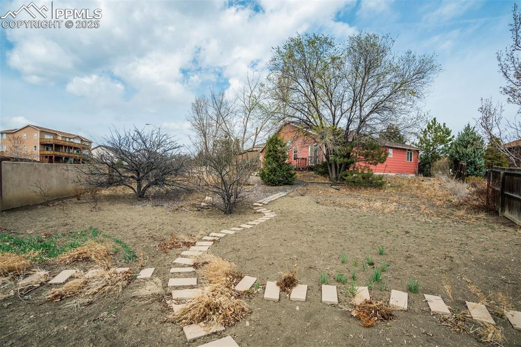 Image 44 of 50: View of yard looking to the home.