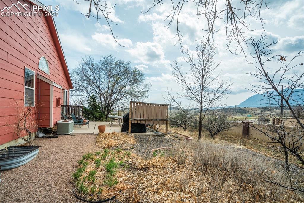 Image 46 of 50: View of back of the home and yard.