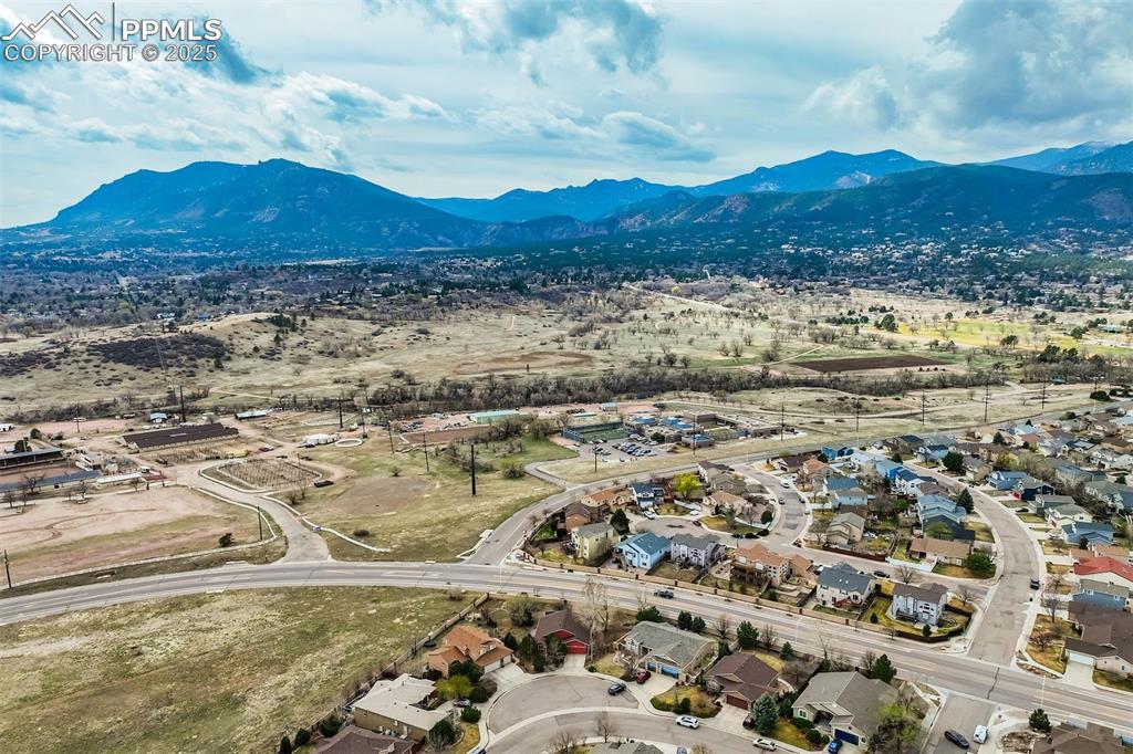 Image 47 of 50: Aerial view with a mountain view. Home is the red ranch front and center o