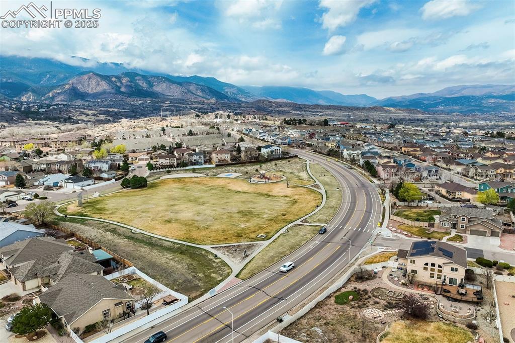 Image 49 of 50: Aerial view of the surrounding mountains and the local neighborhood park wi