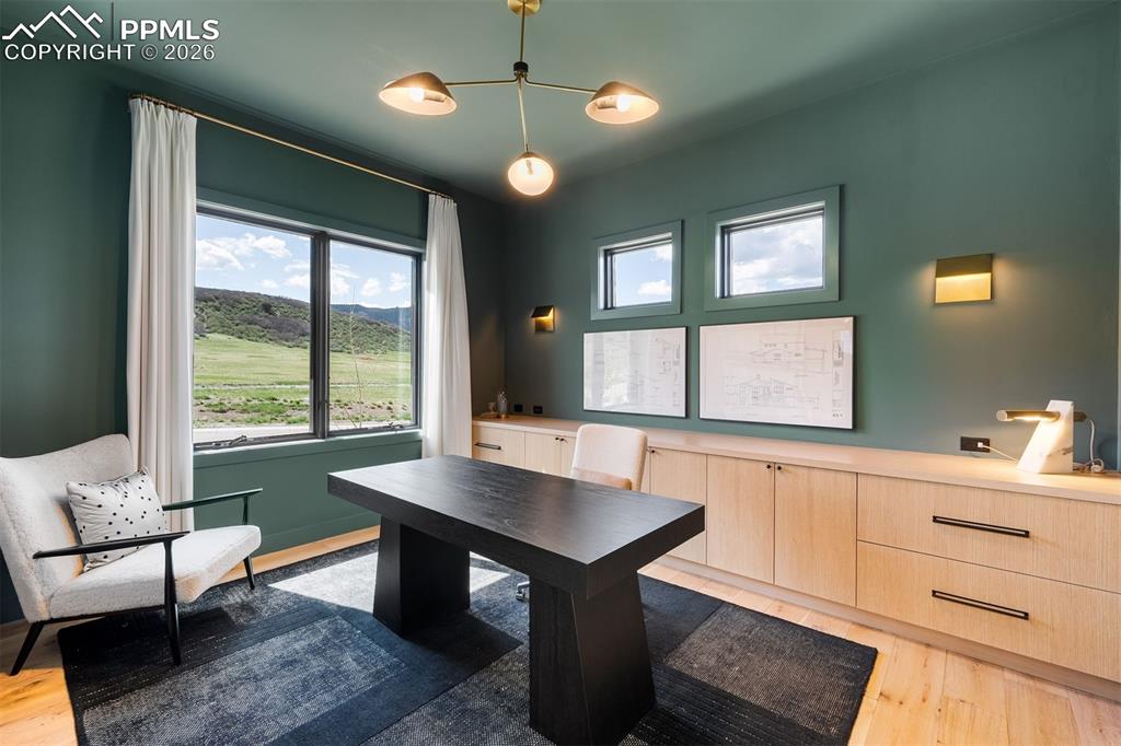 Image 16 of 37: Private office with custom built-ins and expansive views.