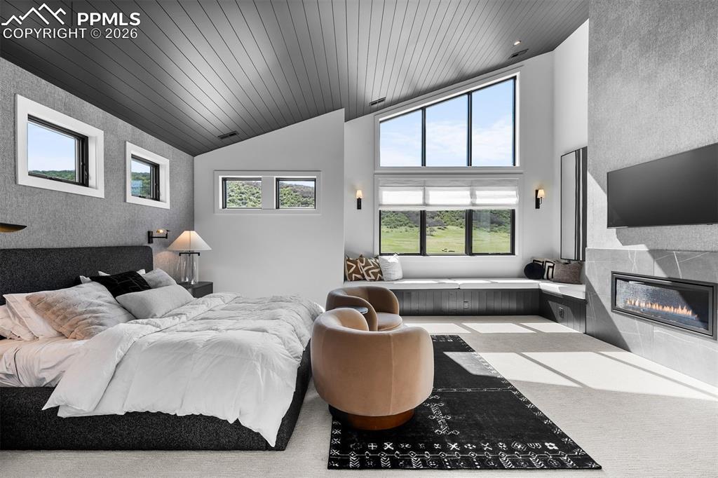 Image 18 of 37: Primary suite with vaulted ceilings and built-in window bench.