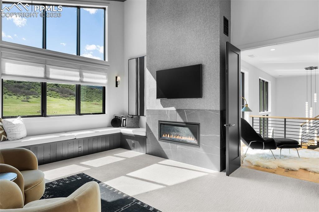 Image 19 of 37: Linear fireplace enhancing the primary retreat.