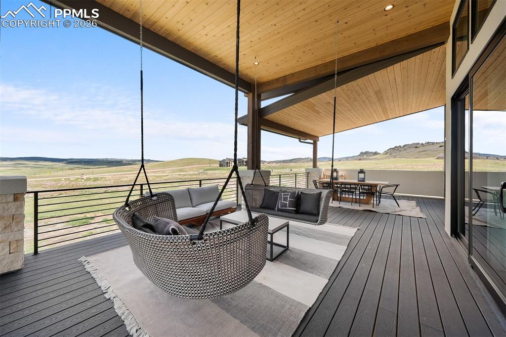 Image 3 of 37: Full-length covered deck designed for seamless indoor-outdoor living.