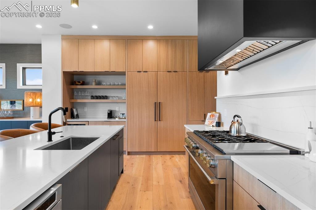 Image 7 of 37: Monogram range framed by white oak cabinetry and clean-lined finishes.