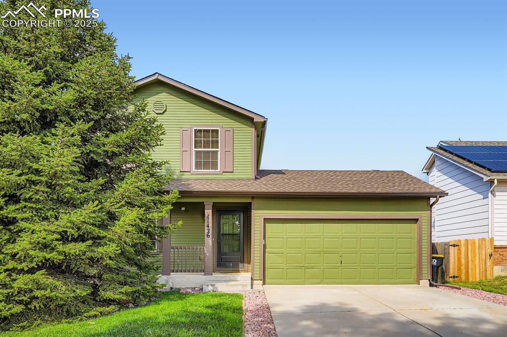Image 2 of 43: Double car garage and mature landscaping