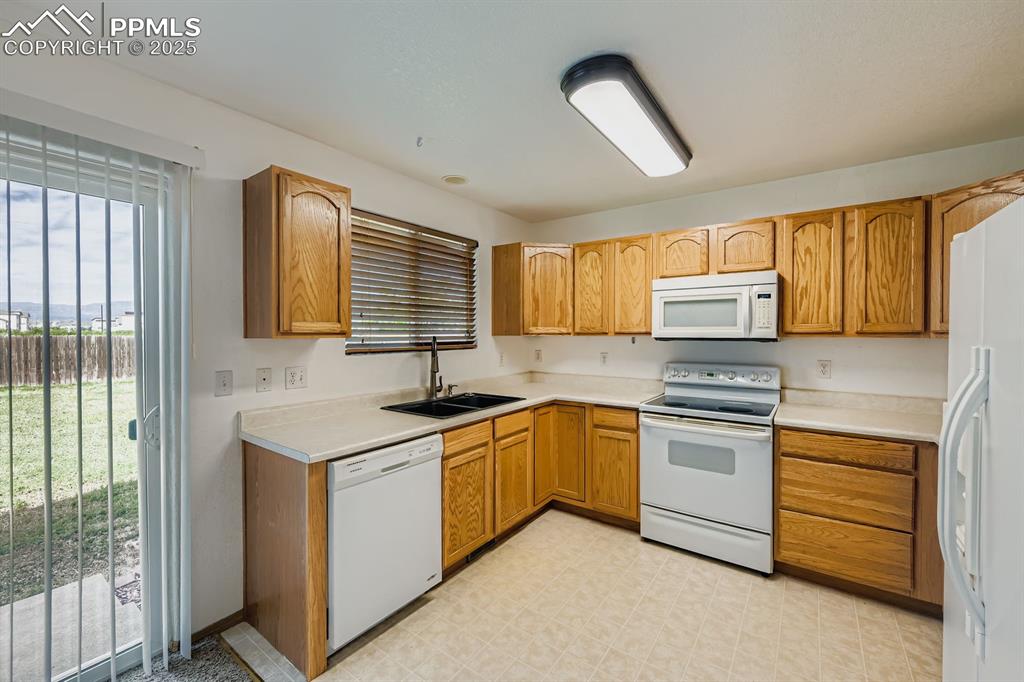 Image 8 of 43: Beautiful cabinetry, walk out to large yard