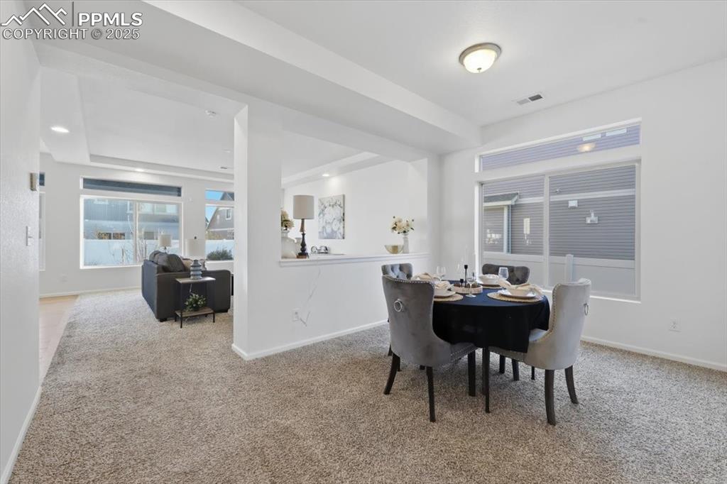 Image 10 of 41: Dining room with light carpet and baseboards