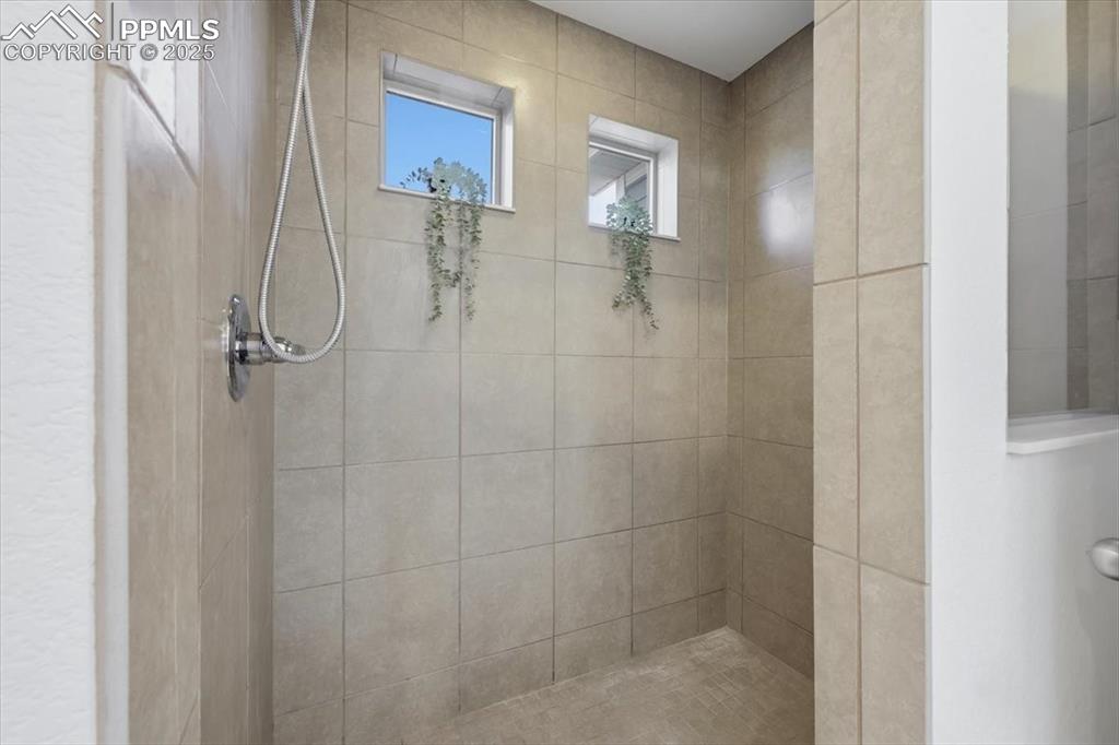 Image 25 of 41: Bathroom with tiled shower