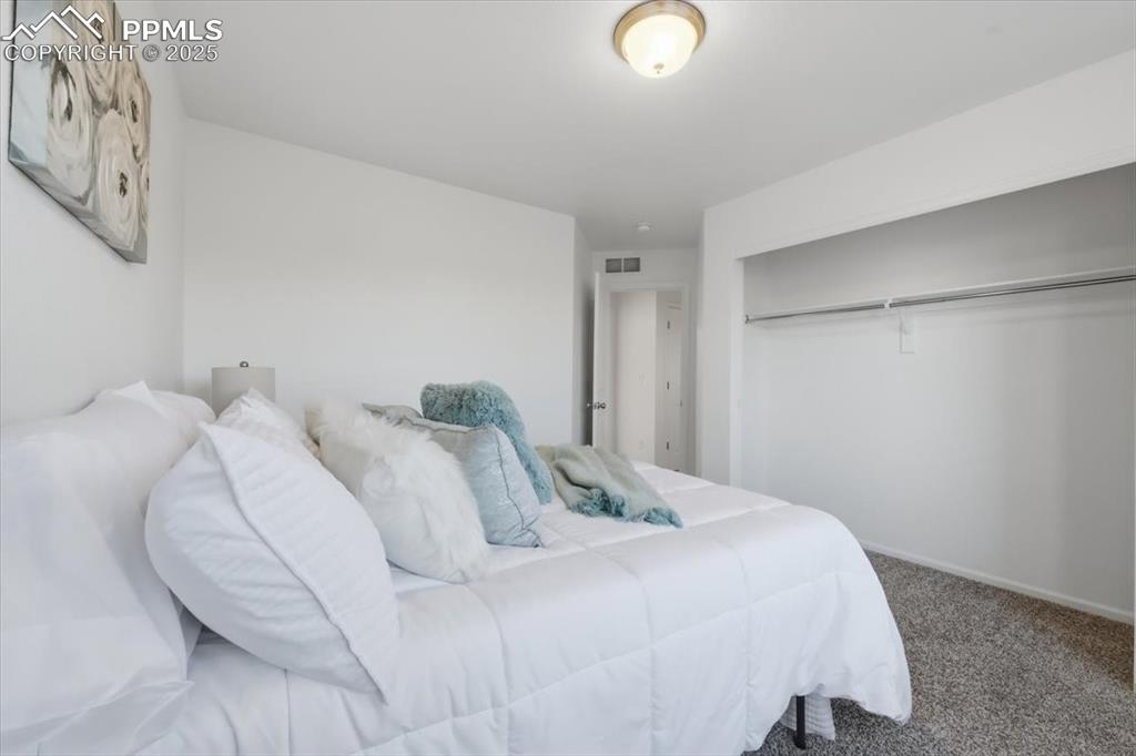 Image 29 of 41: Carpeted bedroom featuring baseboards and a closet
