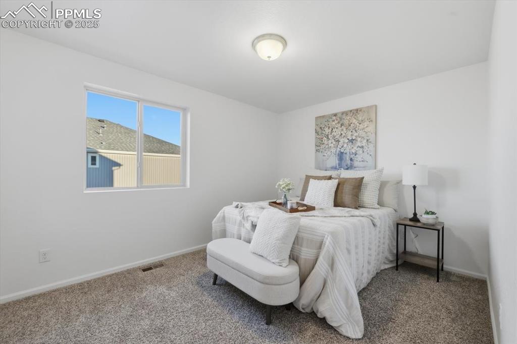 Image 30 of 41: Carpeted bedroom with baseboards