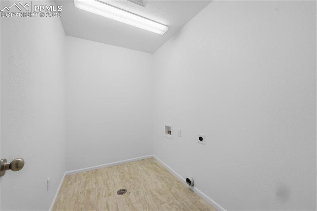 Image 33 of 41: Laundry room with washer hookup, electric dryer hookup, and wood finished f