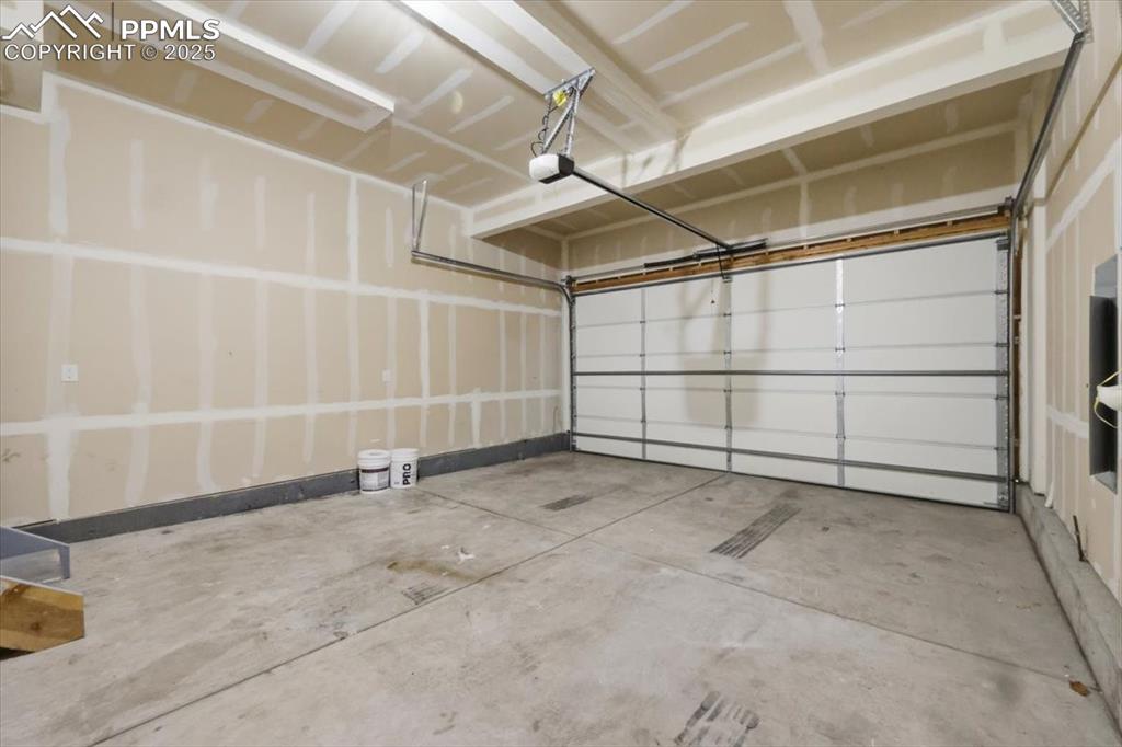 Image 36 of 41: Garage featuring a garage door opener