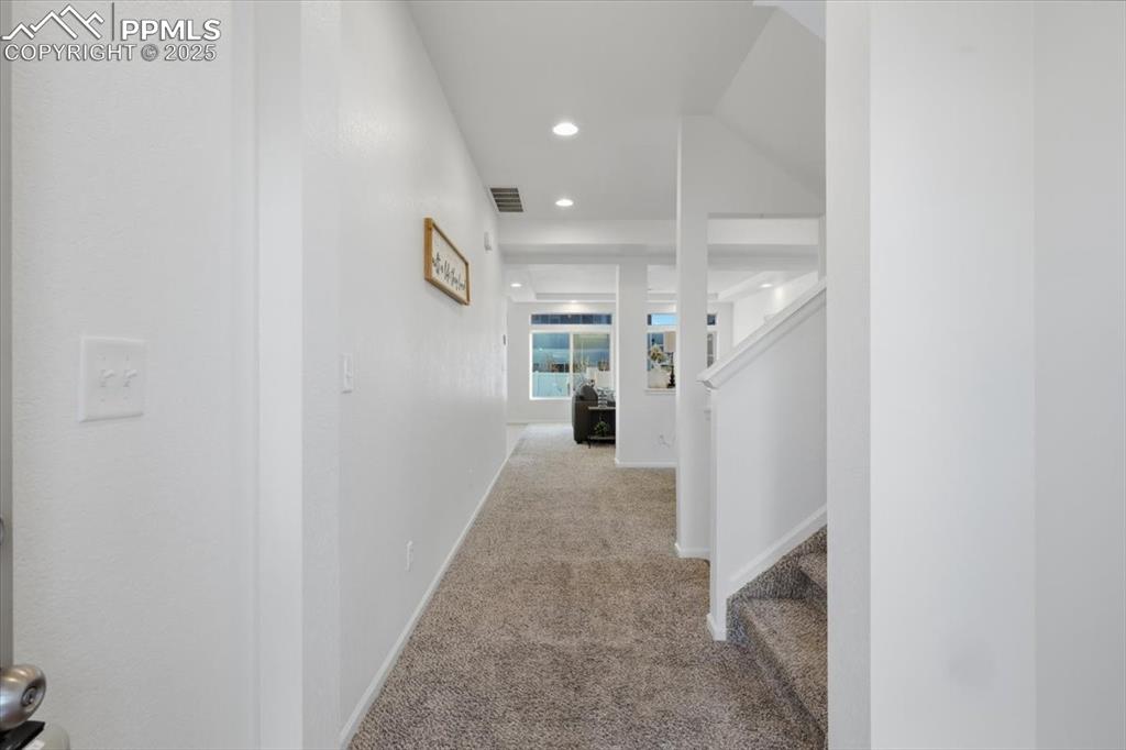 Image 7 of 41: Corridor with carpet, stairs, and recessed lighting