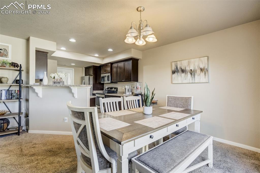 Image 11 of 50: Spacious dining area seamlessly connected to the living room and kitchen, p