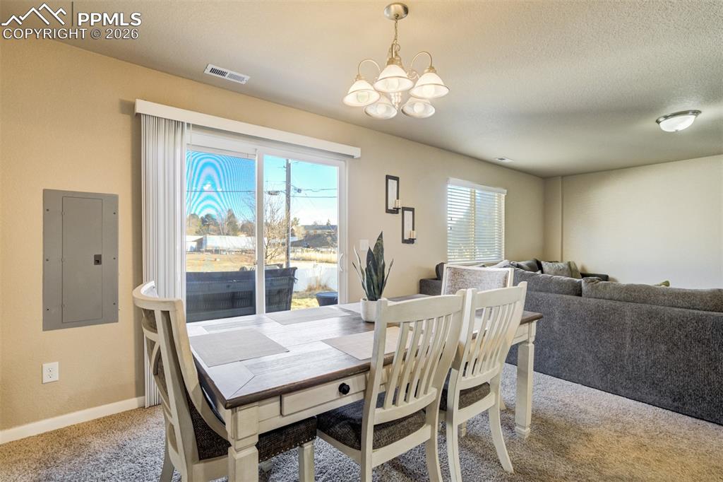 Image 14 of 50: Spacious dining area with neutral tones and ample room for gatherings. Larg
