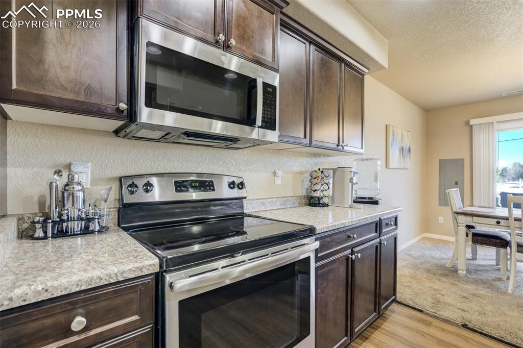 Image 16 of 50: Open kitchen layout with plenty of prep space, stainless steel range and mi
