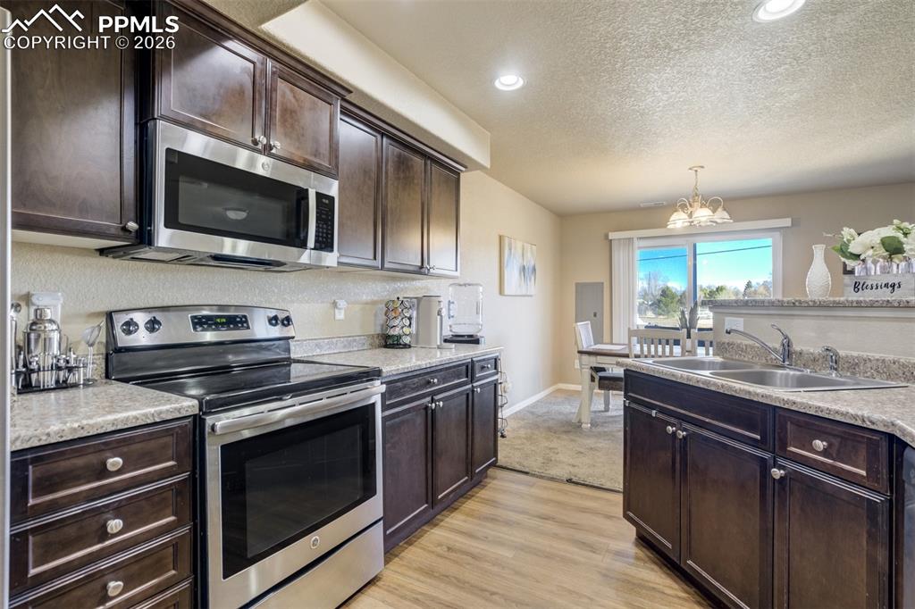 Image 17 of 50: Kitchen opens seamlessly to dining space with natural light and sliding doo