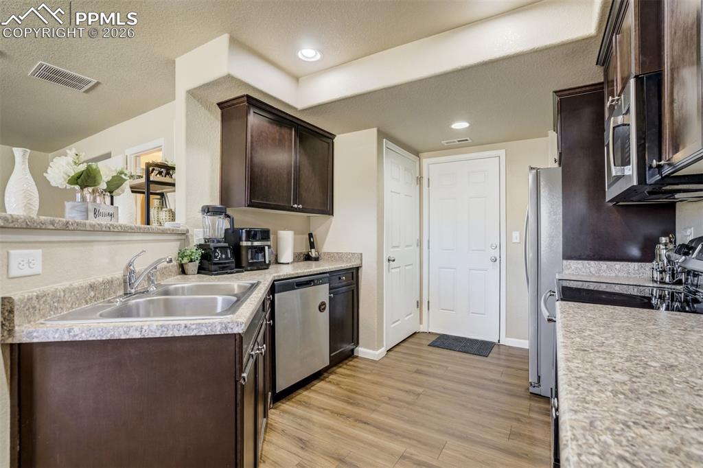 Image 19 of 50: Spacious kitchen with abundant cabinetry, breakfast bar, and open-concept d