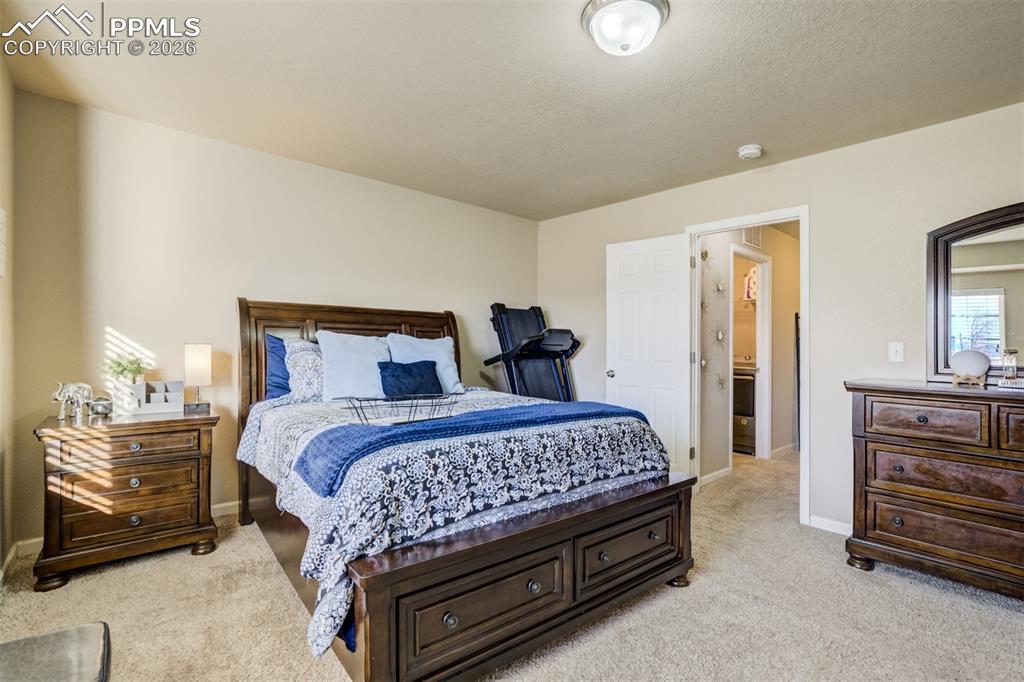Image 23 of 50: Bright and open primary suite with generous layout, neutral finishes, and d
