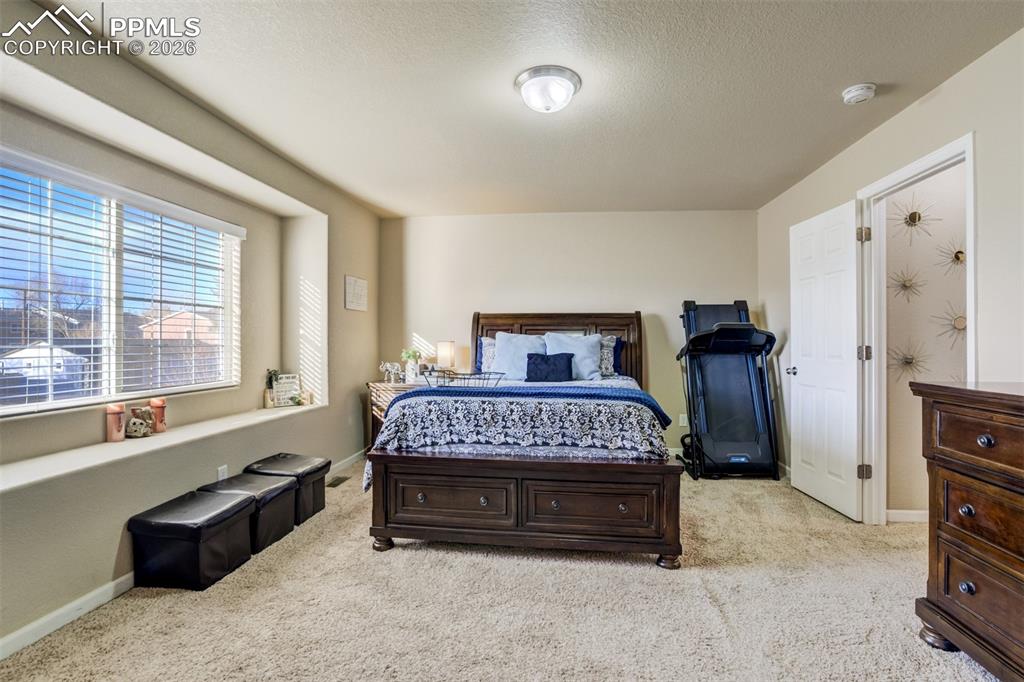 Image 24 of 50: Comfortable primary retreat with plenty of space for additional furniture o