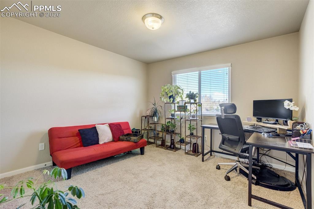 Image 26 of 50: Versatile secondary bedroom or home office with abundant natural light, neu