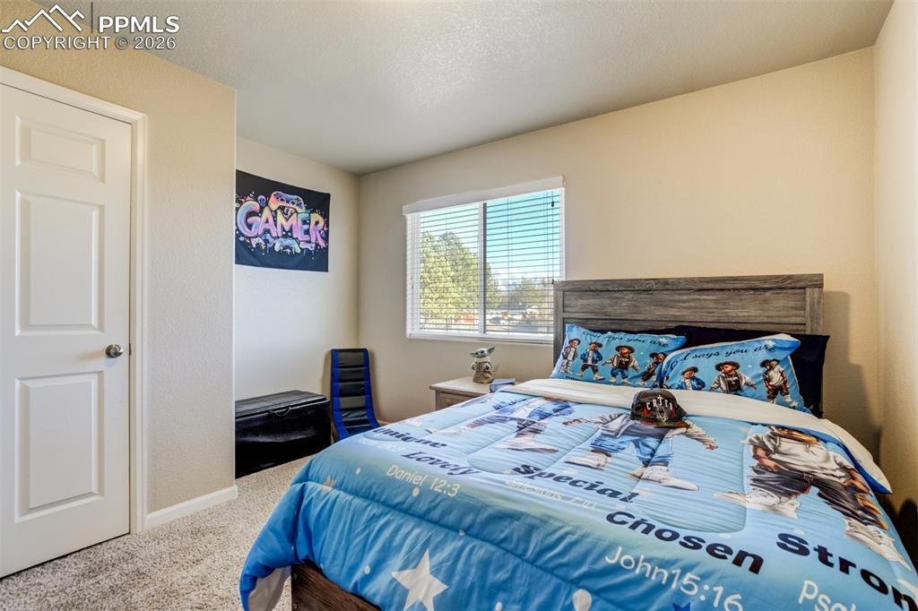 Image 29 of 50: Comfortable and inviting bedroom featuring soft neutral tones, plush carpet