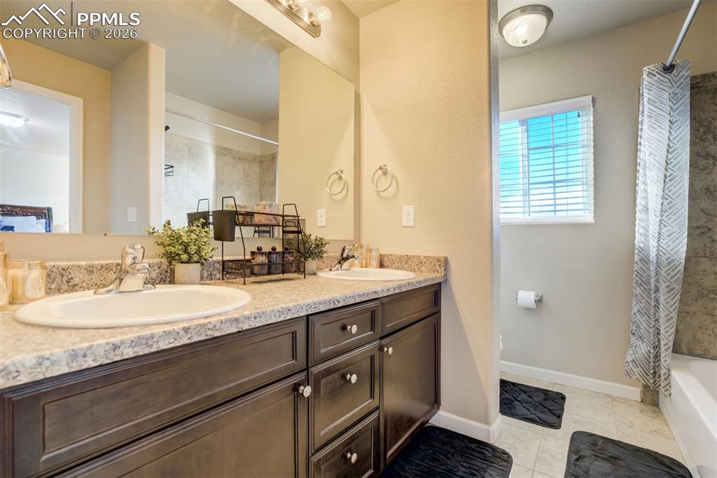 Image 34 of 50: Primary bath with dual sinks, extended vanity, and abundant cabinet storage