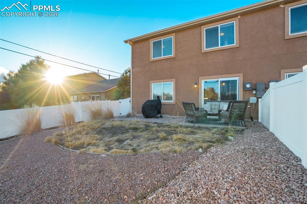 Image 44 of 50: Private outdoor patio space perfect for relaxing or entertaining, with room