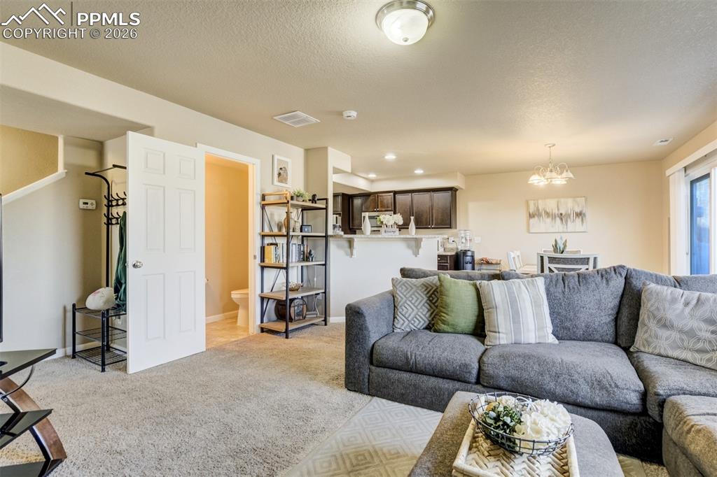Image 8 of 50: Open-concept living and dining area with great natural light, creating an i