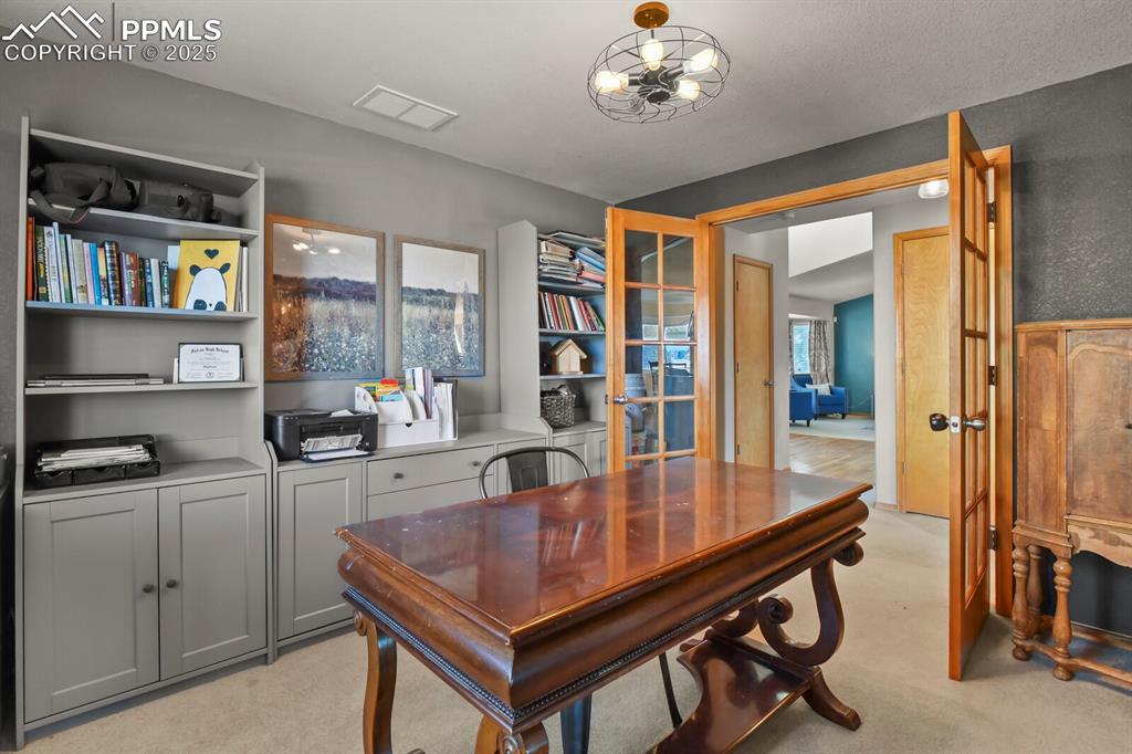 Image 20 of 50: Office space featuring light carpet