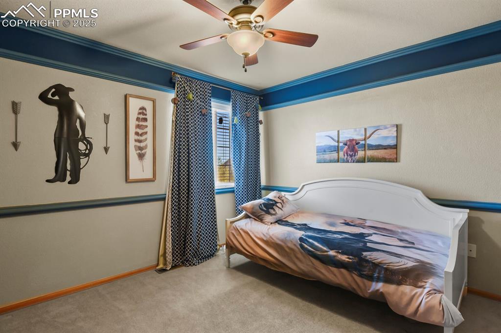 Image 27 of 50: Carpeted bedroom featuring ornamental molding and a ceiling fan