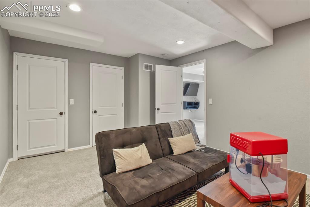 Image 32 of 50: Living area featuring recessed lighting and carpet floors