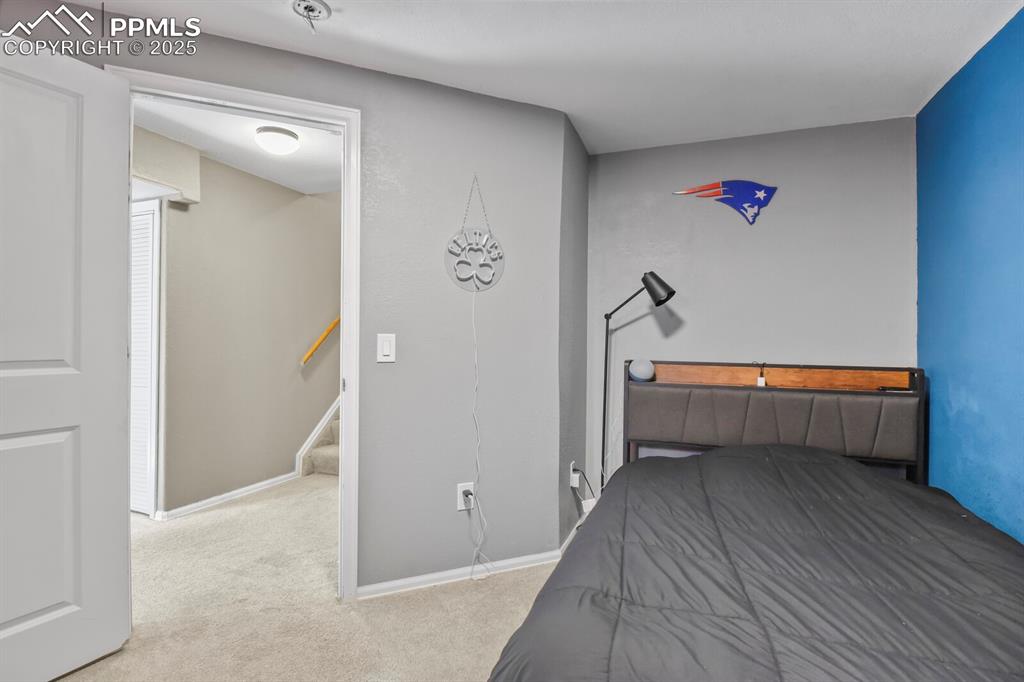 Image 34 of 50: Bedroom with light colored carpet and baseboards
