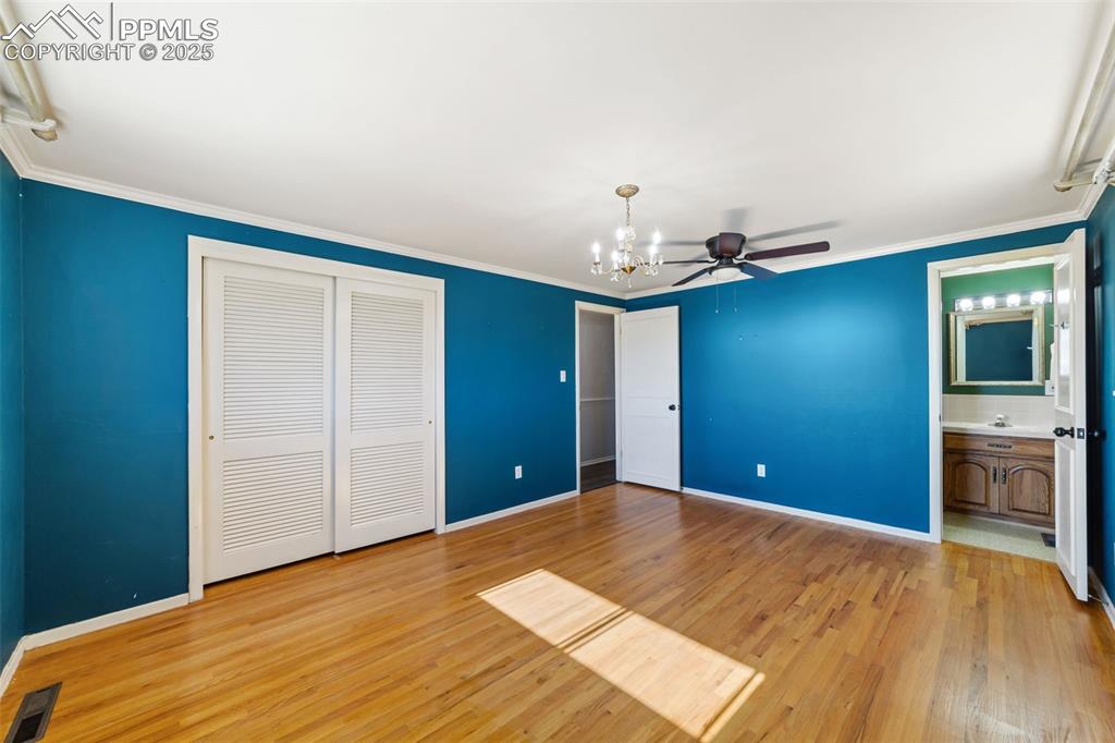 Image 17 of 49: Unfurnished bedroom featuring ornamental molding, light wood-style floors,