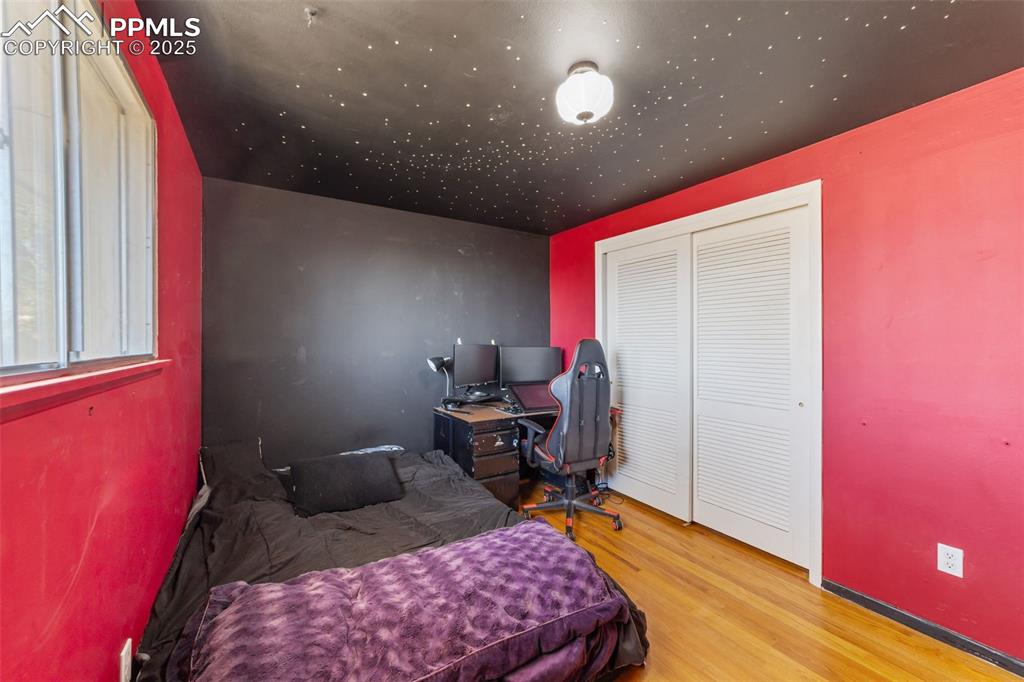 Image 24 of 49: Bedroom featuring light wood-type flooring, an office area, and a closet