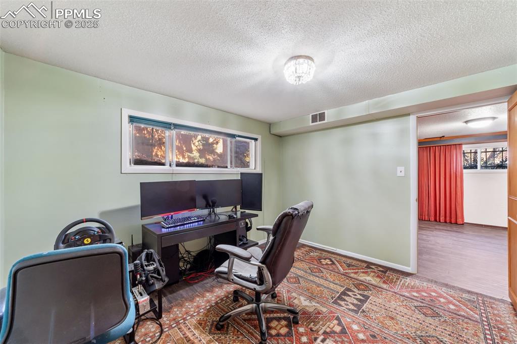 Image 32 of 49: Office space featuring a textured ceiling