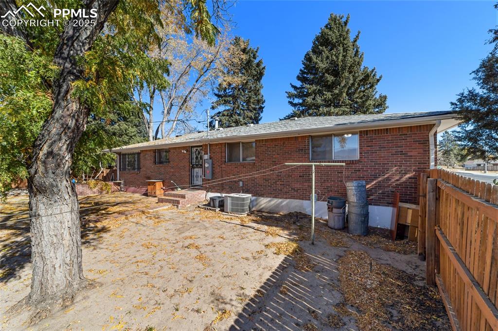 Image 41 of 49: Back of house featuring brick siding
