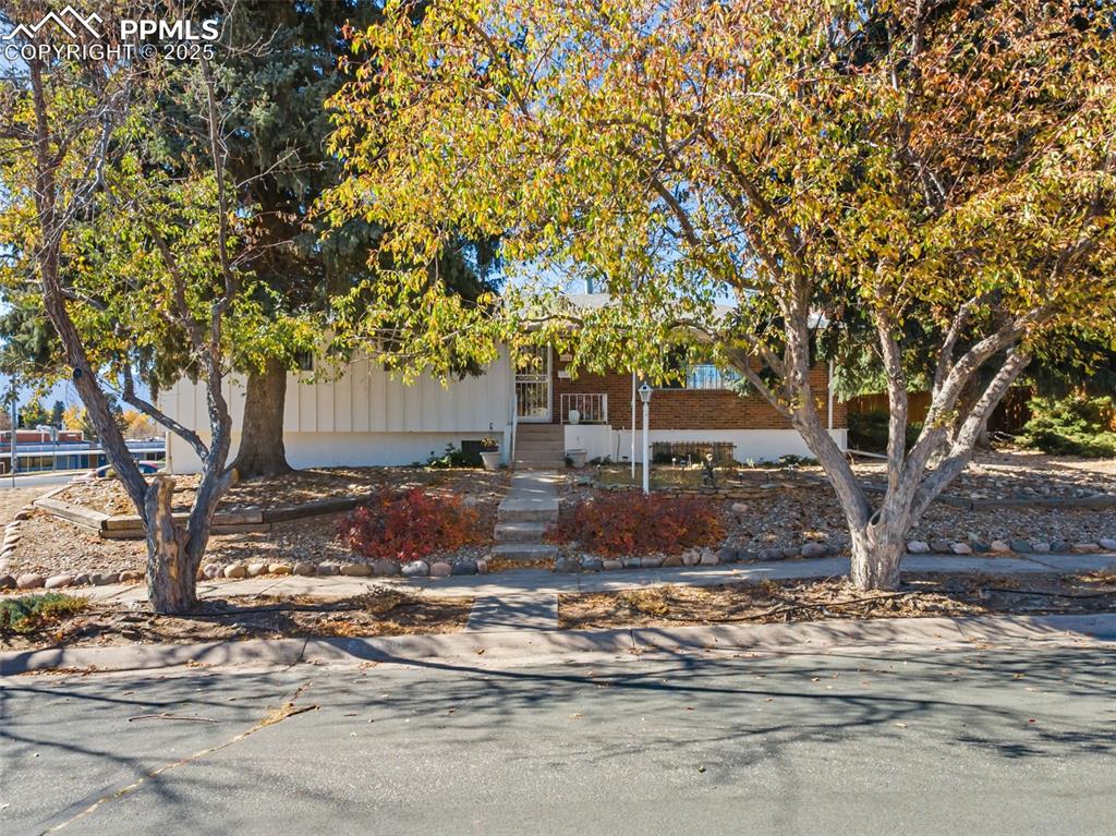 Image 42 of 49: View of front of property featuring covered porch and brick siding