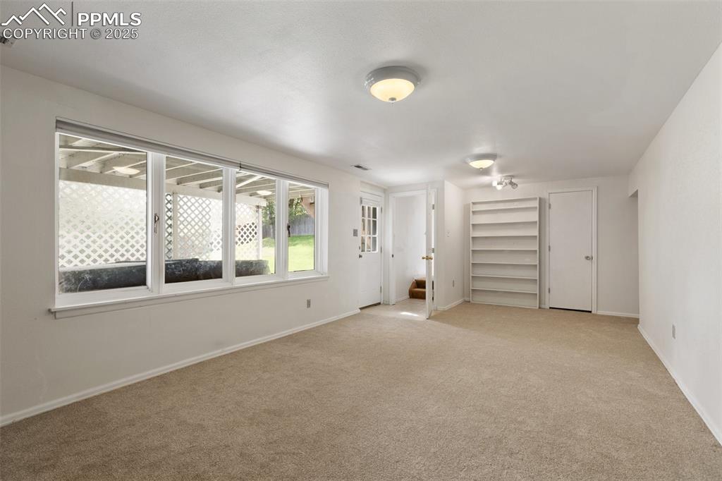 Image 25 of 50: Lower level family room with walk out to yard and hot tub