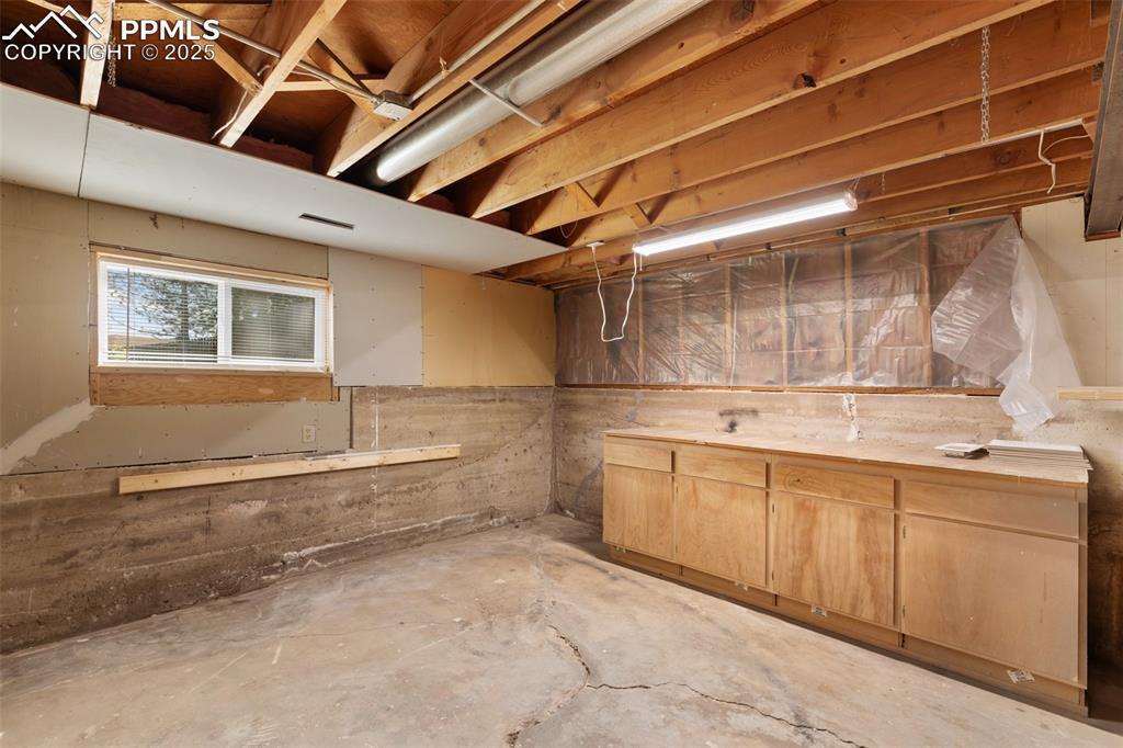 Image 40 of 50: Lower level workshop with extra storage