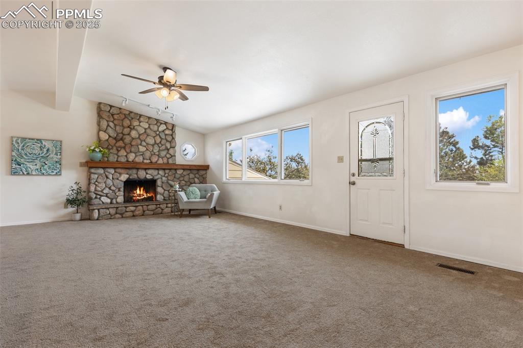 Image 9 of 50: New carpet, cozy fireplace in living room