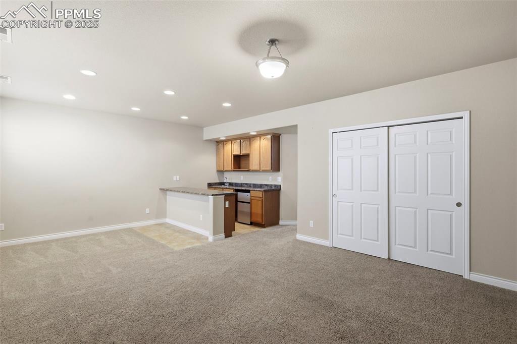 Image 23 of 34: Great Room in Basement Level with Wet Bar