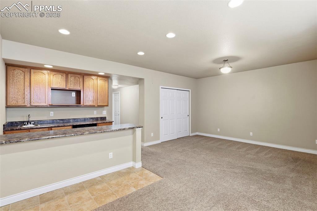 Image 33 of 34: Great Room in Basement Level with Wet Bar
